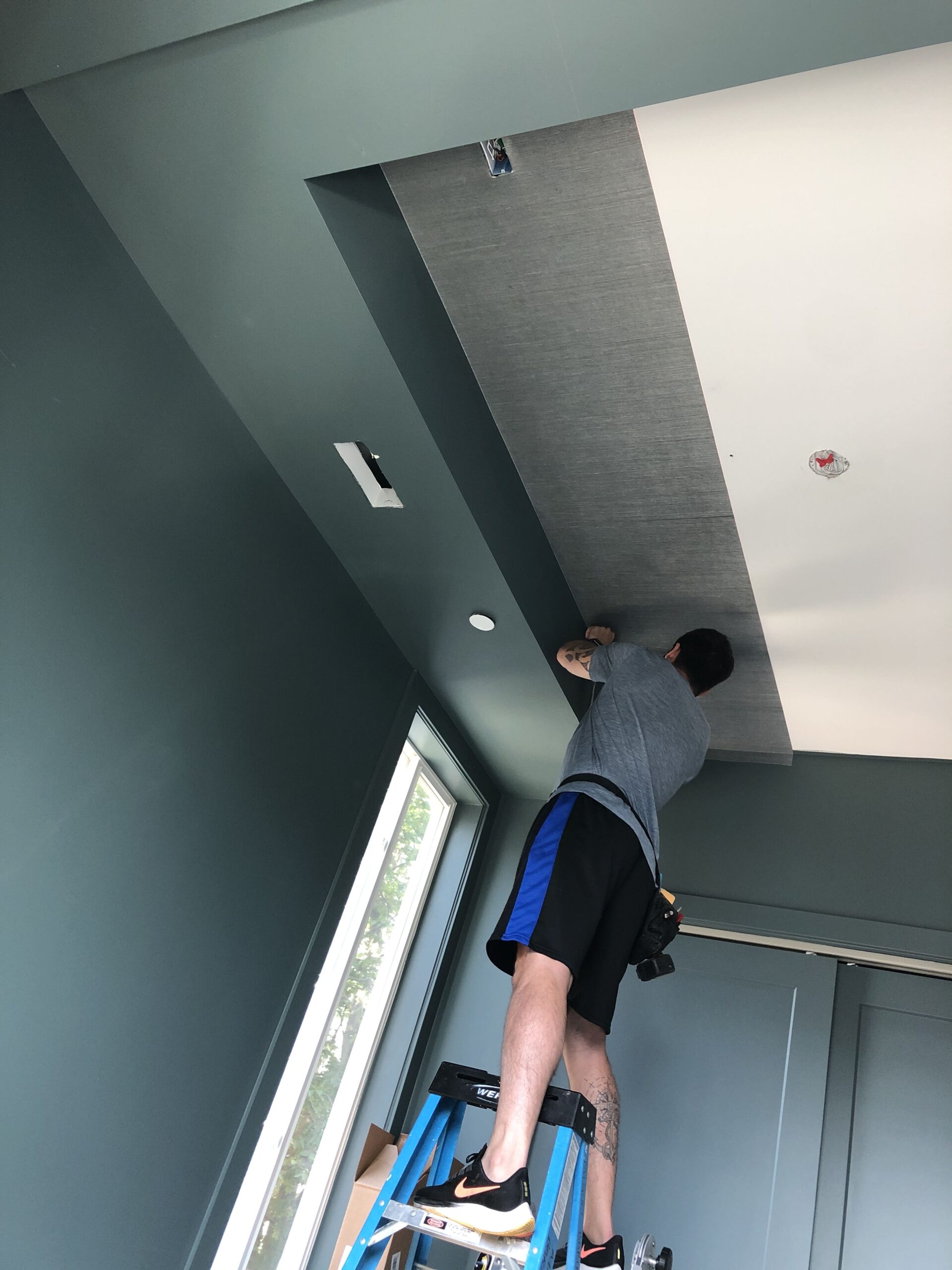 Dark blue grasscloth wallpaper ceiling installation in Costa Blanca, Spain, by Costa Blanca Wallpaper