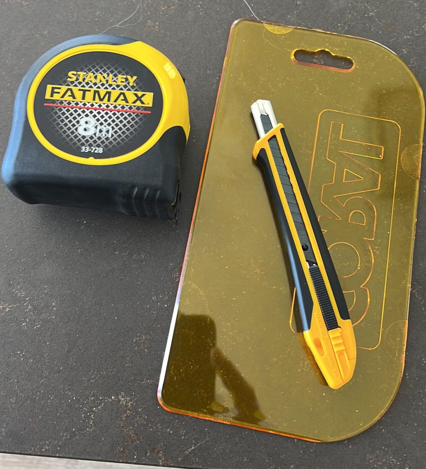 Utility knife, smoothing tool and measuring tape.